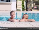 Mother And Son Have Fun By A Swimming Pool 158737898 avec Piscine O&amp;#039;Bya